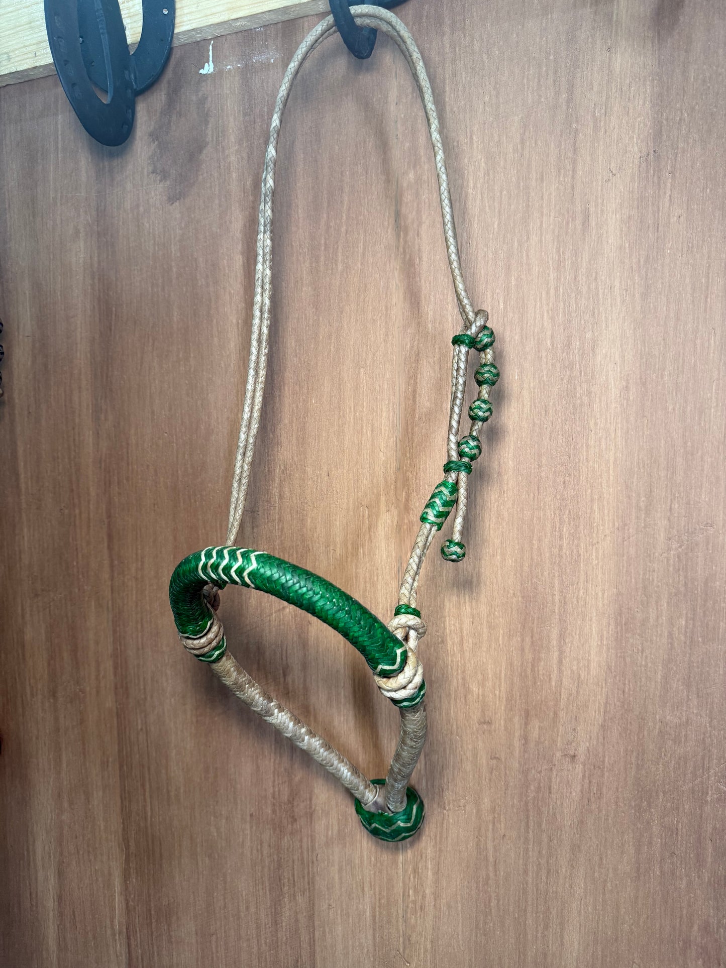 Green 5/8” rawhide braided bosal with natural accents & matching rawhide hanger with black knots