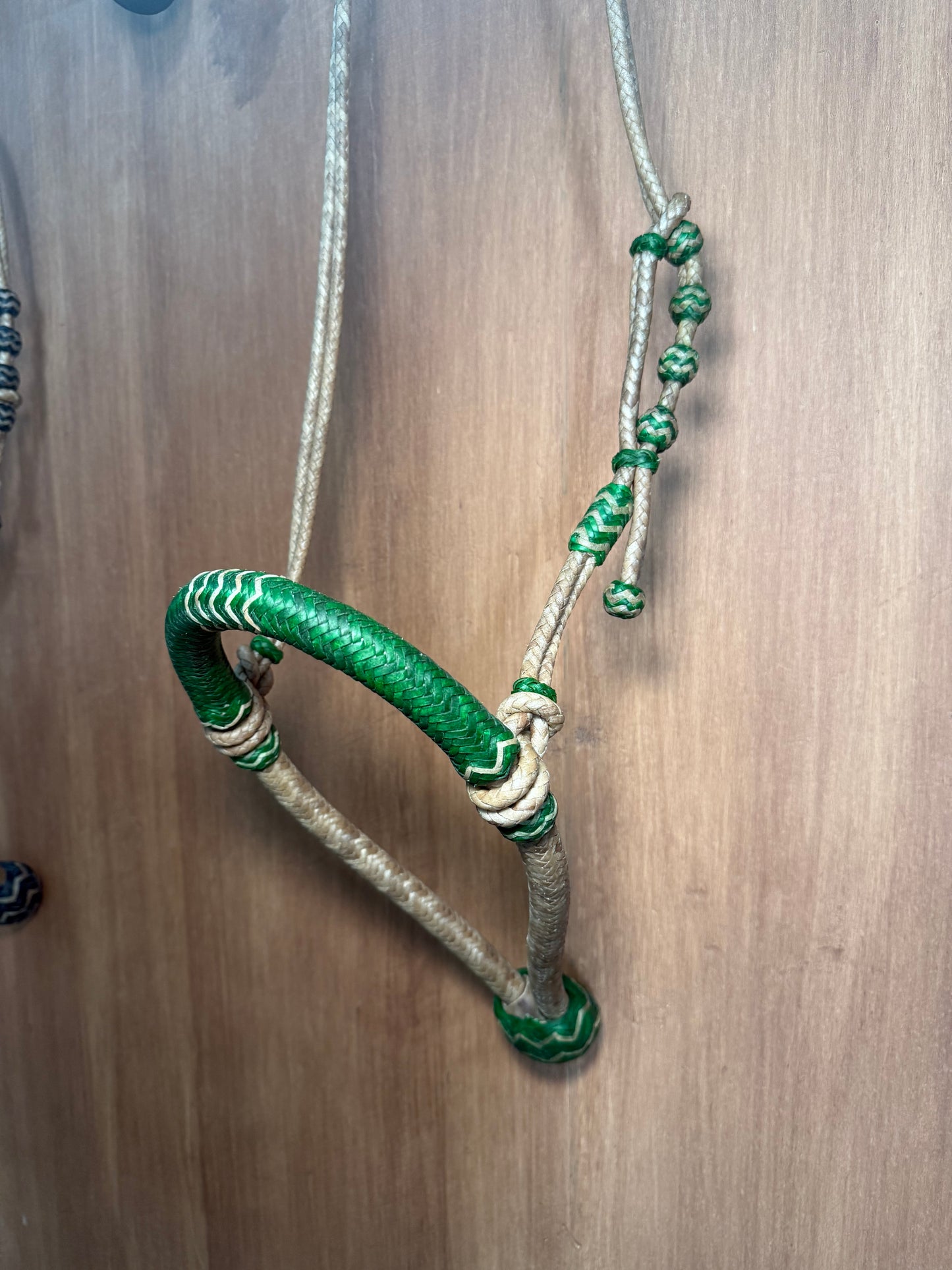 Green 5/8” rawhide braided bosal with natural accents & matching rawhide hanger with black knots