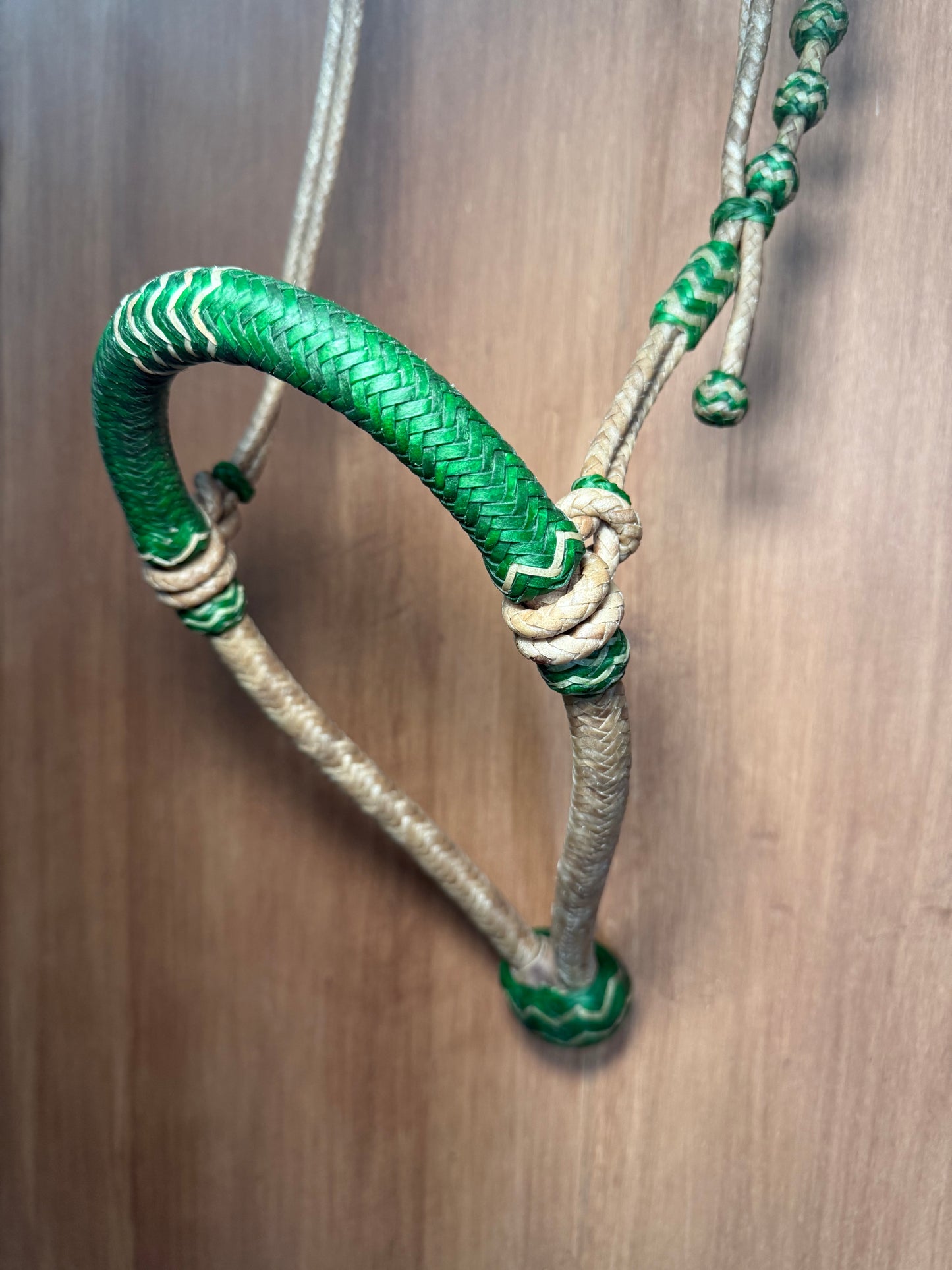 Green 5/8” rawhide braided bosal with natural accents & matching rawhide hanger with black knots