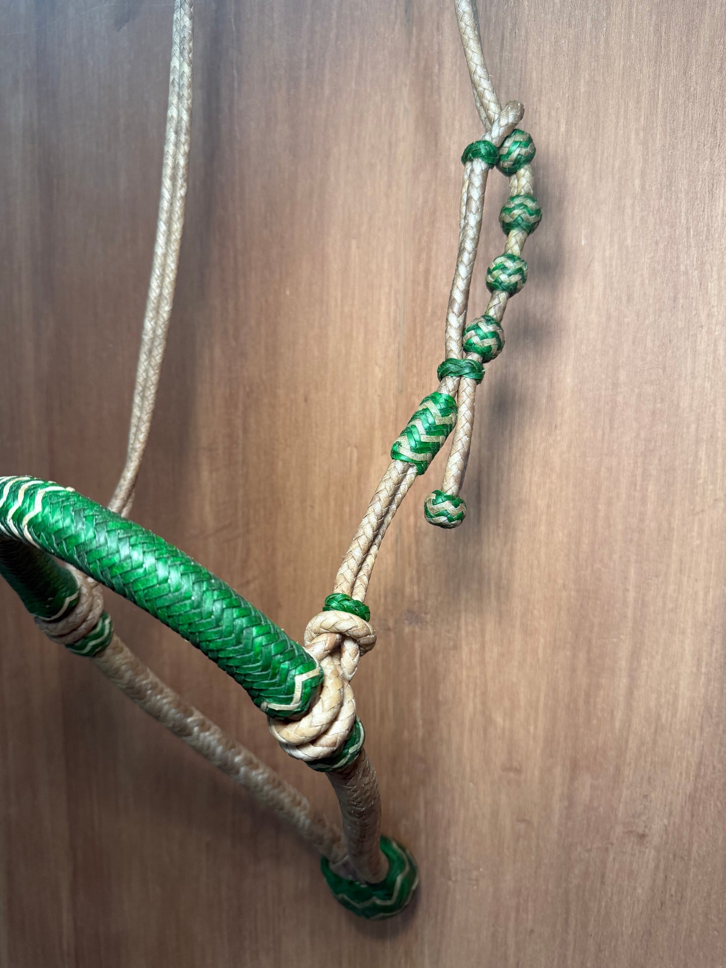 Green 5/8” rawhide braided bosal with natural accents & matching rawhide hanger with black knots